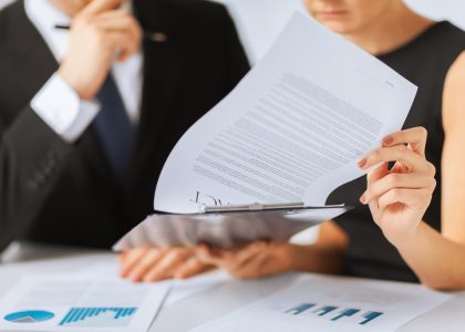 business, office, law and legal concept - picture of man and woman hand signing contract paper